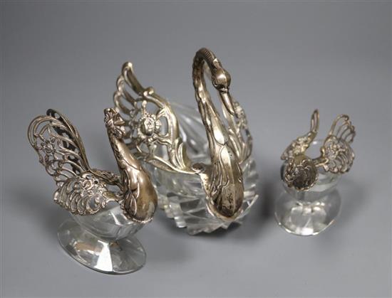 Three assorted metal and glass bon bon dishes, including swan stamped silver and cockerel, tallest 10.4cm.